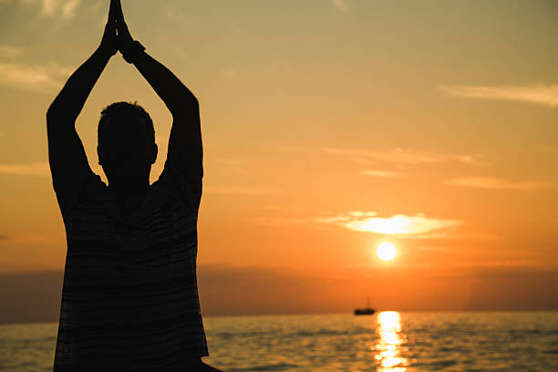 istock Man silhouette with sunset on the background 516369308