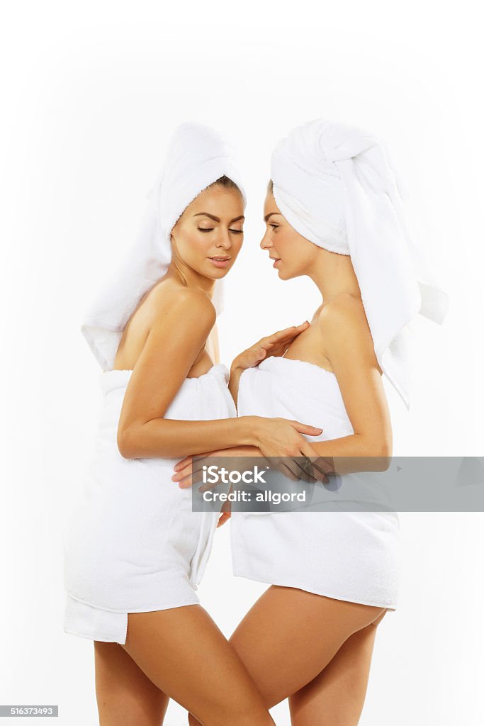 Two happy teenage girls after showering in towels. Two teenage girls after showering in towels Adult Stock Photo