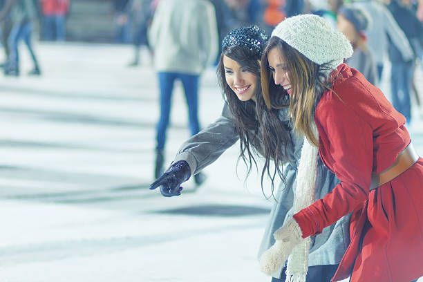 istock two girls ice skating 516374657