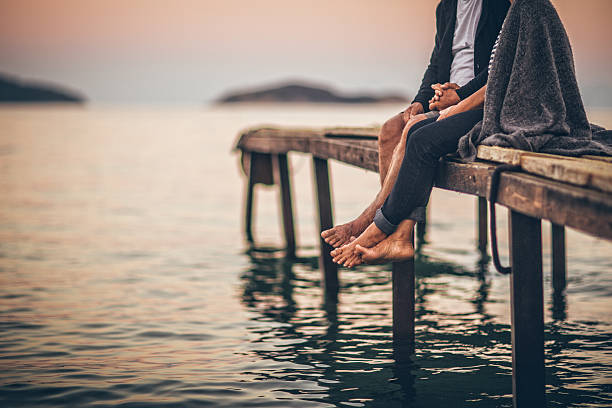 romantici sul dock - holding hands couple senior couple togetherness foto e immagini stock