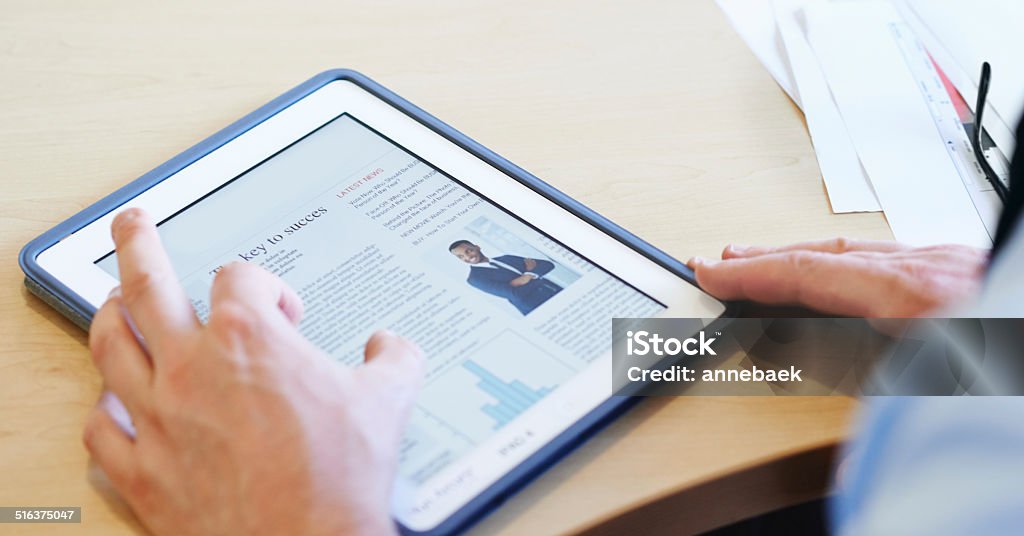 Success is in your reach Cropped shot of a businessman using a digital tablet Article Stock Photo