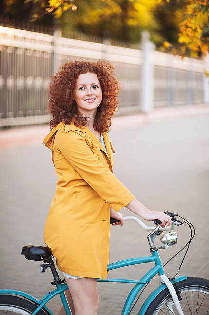 istock Happy young woman with bike 516376539