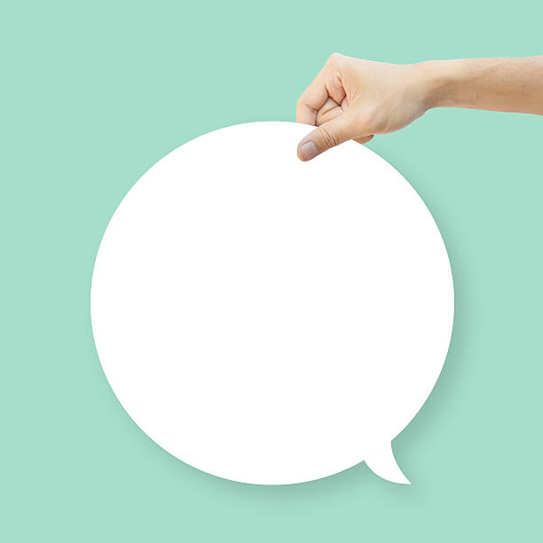 istock Hand hold white bubble quote chat on green background 516376701