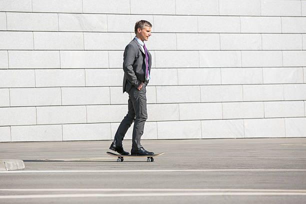 istock Businessman skateboarding on street 516377489