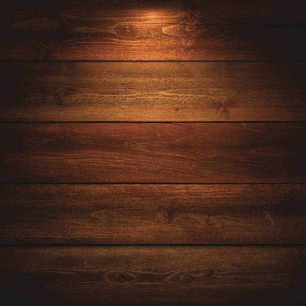 Lit Wooden Background Lit realistic wooden wall. wood material stock illustrations