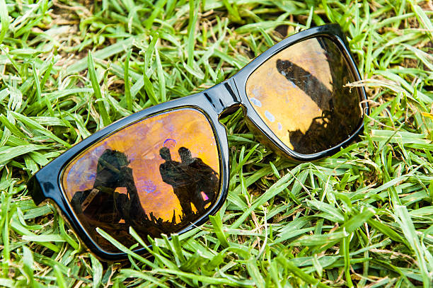istock Black sunglasses on green grass with polarized lenses 516378851