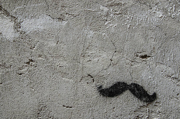 Black hipster moustaches drawn on a wall