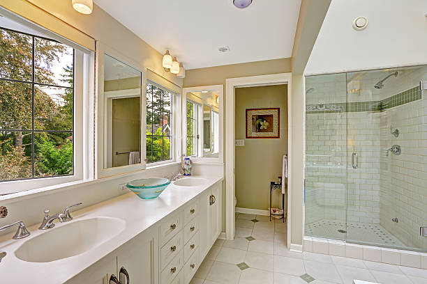 istock Spacious bright bathroom with glass door shower 516378937