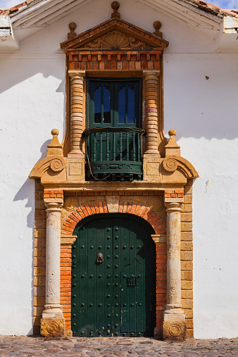 Detail of colonial Spanish architecture in the town of Villa de Leyva in Colombia. Founded in 1572 and located at just over 7000 feet above sea level on the Andes Mountains, the whole town was declared a National Monument in 1954 to protect it's colonial architecture and heritage. It is located in the Department of Boyaca, in the South American country of Colombia.   Photo shot in the morning sunlight; vertical format.