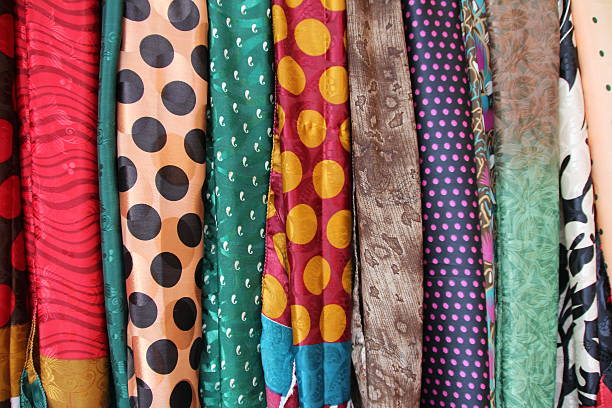 Rajasthan, India.  January 26, 2012.  Colorful silk fabrics hanging for sale in an outdoor market.