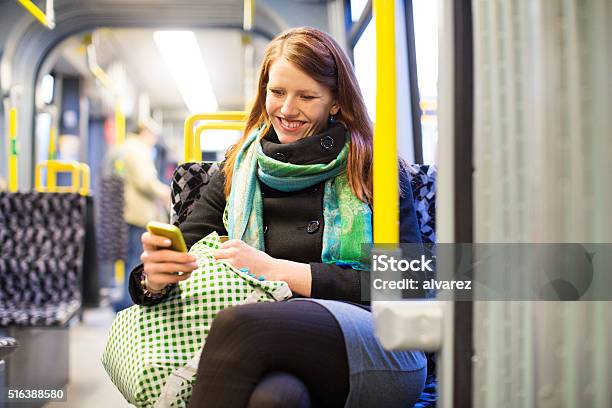 Happy Young Traveling By Subway Train Using Mobile Phone Stock Photo - Download Image Now