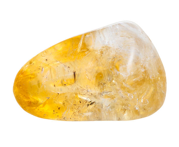 pebble of citrine mineral gem stone isolated stock photo