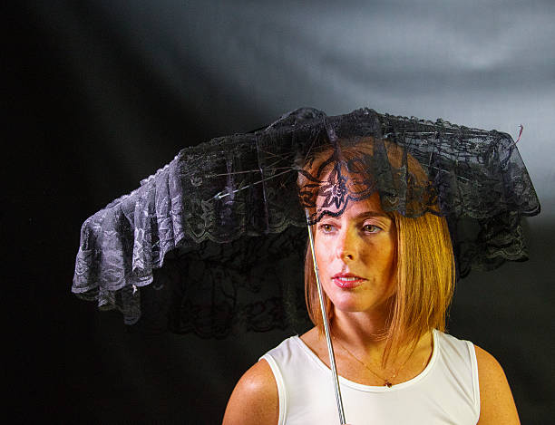 istock Attractive Red Head Female With A Black Parasol 516388910