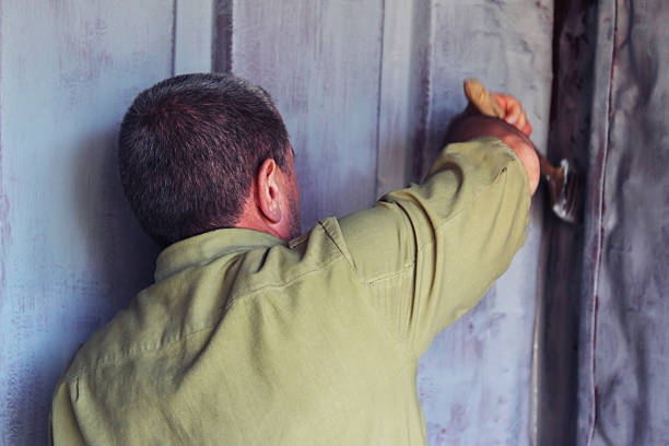 istock Man paints the walls of iron 516389262