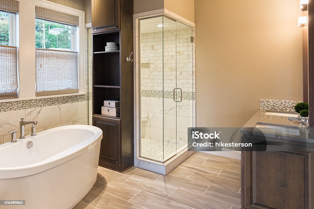 Bathroom in Luxury Home: Bathtub and Shower Bathtub and shower in new luxury home Home Addition Stock Photo