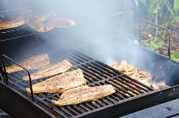 Wood smoked smoking mullet fish stock photo