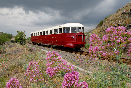 Catania, Italy - June 03, 2008: Tourist railway Circumetnea. The historic train Fiat, named Littorina, that travels around the Etna volcano, in the middle of the lava.