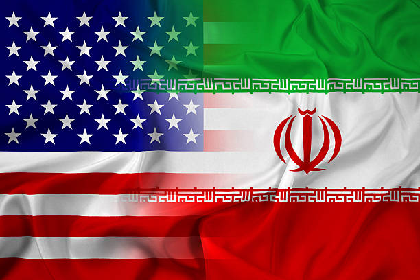 istock Waving Iran and USA Flag 516391629