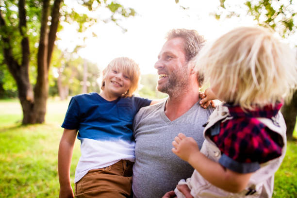 istock Modern dad takes his two children in his arms 516393612