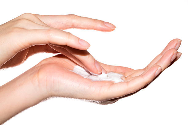 Female hands with cream isolated on white