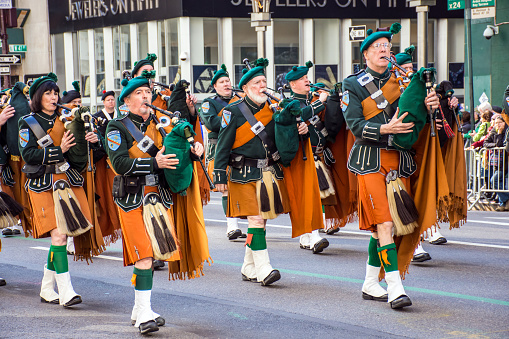 New York, NY, USA - March 17, 2016: Marchers with bagpipes dressed in kilts march in the St Patrick’s Day Parade on on 5th Ave in New York City.