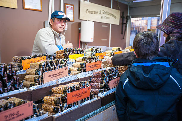 Madrid, Spain  - December 22, 2013: Christmas market in Madrid, Spain. Man vendor selling candied food to customers.