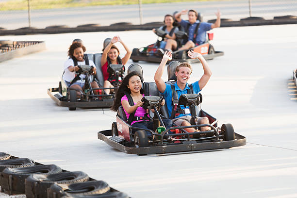 istock Group of teens riding go carts 516393917