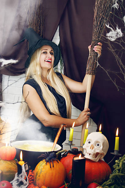 istock blonde witch with a broom, tinted 516395025