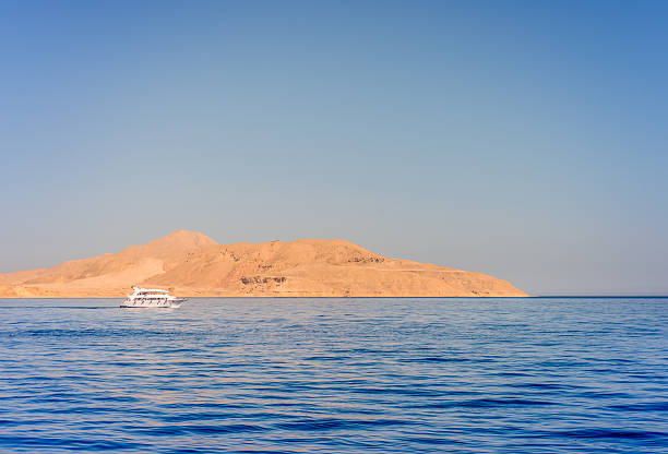 istock Pleasure boat or tour boat off a reef 516395434