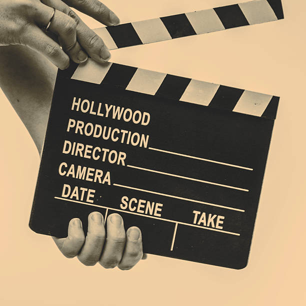 istock Movie flapper in woman´s hands on white background 516396060