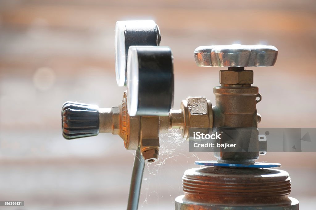 Cylinder valve with the Gas Regulator Cylinder valve with the Gas Regulator in the sunshine Natural Gas Stock Photo