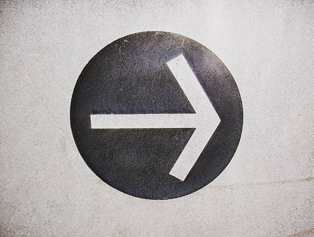 istock Arrow Carved on a Weathered Stone 516396655