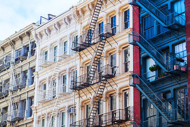 facade of old buildings in Soho, NYC facade of old buildings with typical fire escape stairs in Soho, Manhattan, New York City soho new york stock pictures, royalty-free photos & images