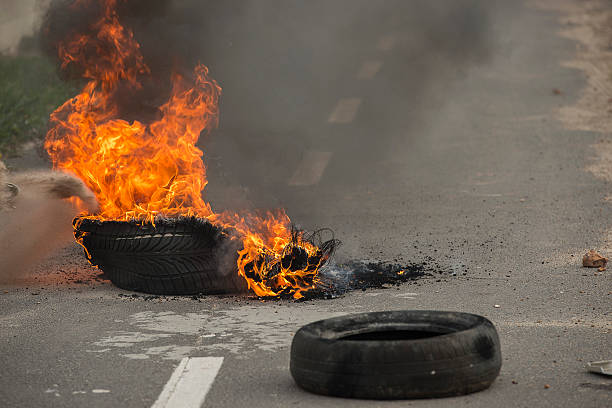 Burning tires in a riot Burning tires on the road at a riot in protest strike protest action photos stock pictures, royalty-free photos & images