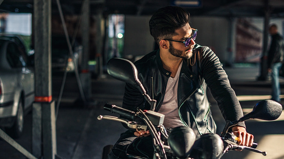 Handsome biker posing on a motorcycle.