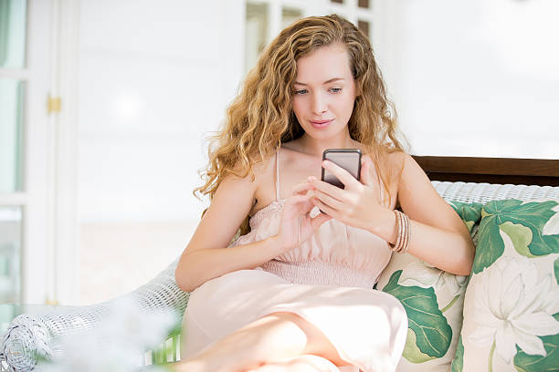 istock young beautiful girl chatting with her smartphone 516400514