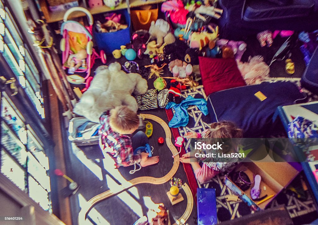 Playing nice Two kids from above in a messy interior Messy Stock Photo