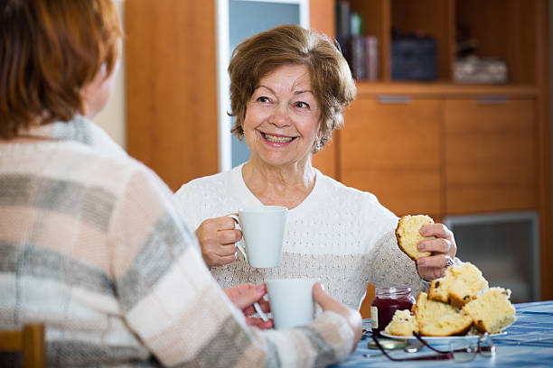 istock Positive female pensioners drinking coffee and chatting 516401262