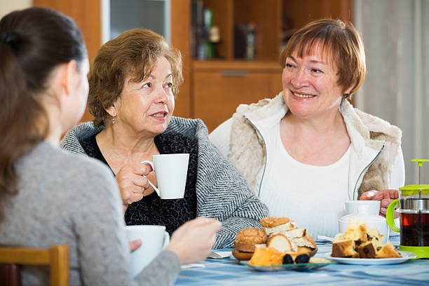 istock Young female and mature women drinking tea and talking 516401508