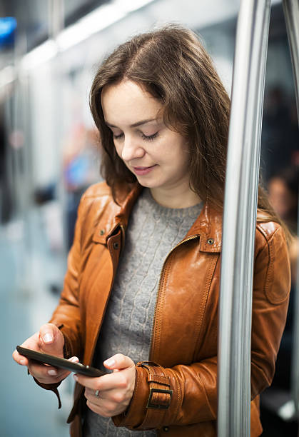 istock Woman with smartphone at subway 516402264