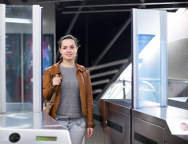 istock Girl passing ticket barrier in subway 516402324
