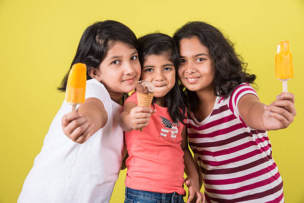 tres monada pequeño indio niños comiendo crema de hielo - cousin fotografías e imágenes de stock