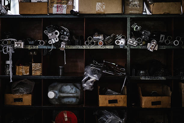 Still image of bicycle repair parts and components stocked on well-used shelves in a grungy workshop