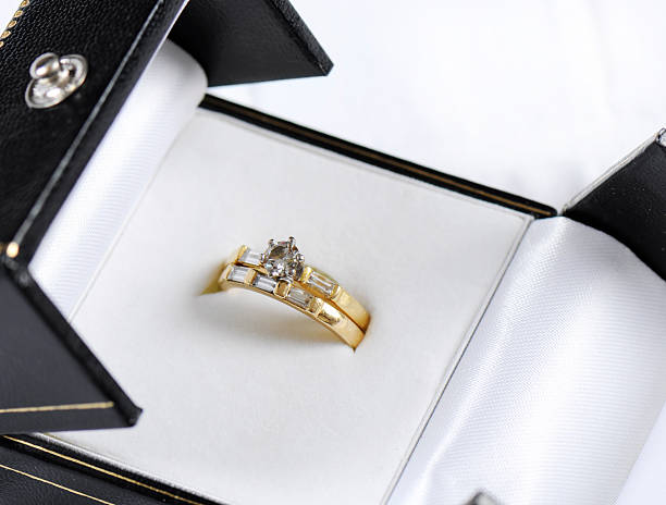 istock Wedding and diamond engagement rings in opened jewelry box 516407205