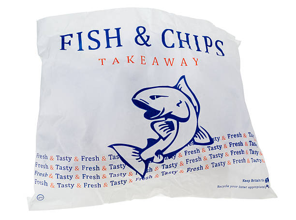 London, England - January 11, 2014: Bag of Takeaway Fish and Chips, isolated on a white background.