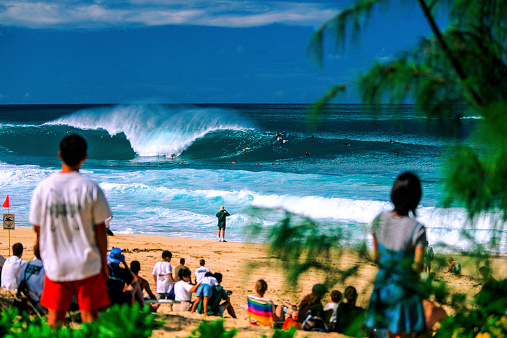 Haleiwa, Hawaii, USA – December 10, 2002: Surfing at the Banzai Pipeline on the north shore of Oahu, famous for big waves in the winter surf season.