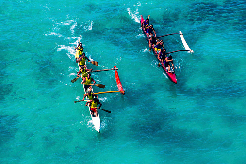 Honolulu, Hawaii, USA – August 24, 2002: Two racing outrigger canoes near the finish line at the Hawaii OceanFest Festival at Waikiki Beach.