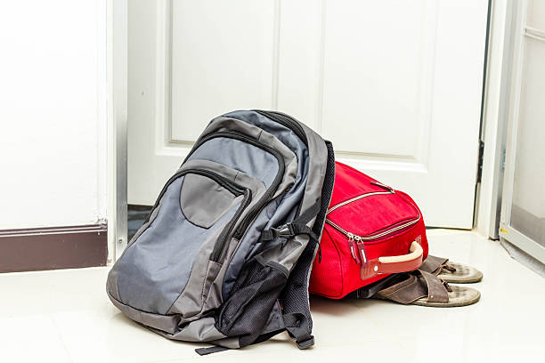 istock red travel bag , backpack and shoes 516411223