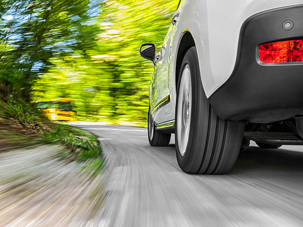 driving in the curve - car tire road speed stock-fotos und bilder