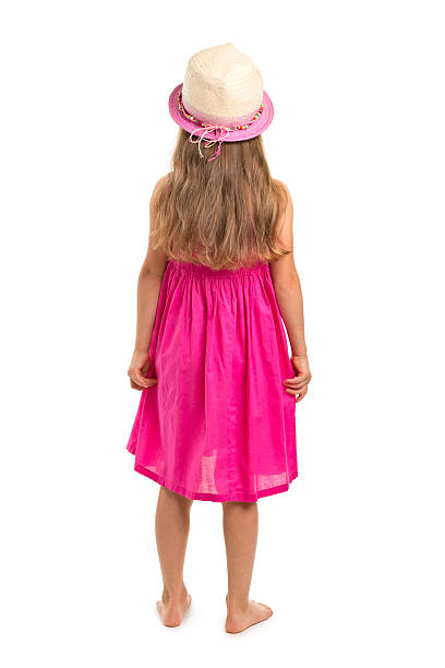 Smiling baby girl 4-5 year old wearing big hat outdoors. Looking at camera. Childhood.